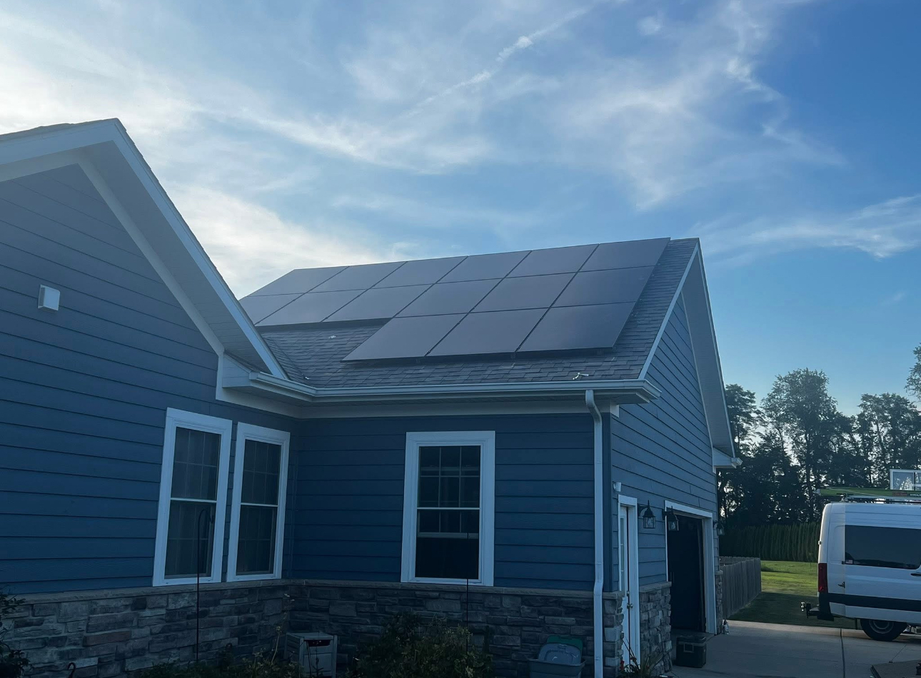 Residential home with rooftop solar installation and service van